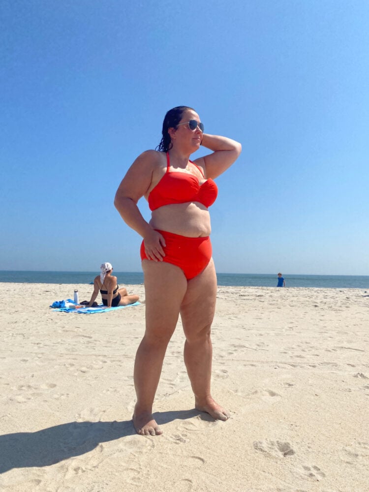 Alison Gary of Wardrobe Oxygen on the beach of Davis Park Fire Island, wearing an orange bikini 